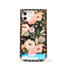 Load image into Gallery viewer, A luxury iPhone case by PURITY with a glossy surface and a floral design, including shades of pink, yellow, and white flowers with a black background.