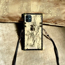 Load image into Gallery viewer, iPhone case with white marble design and gold accents.