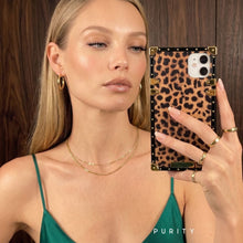 Load image into Gallery viewer, Woman holding a luxury leopard print iPhone case by Maison Purity
