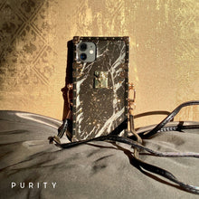 Load image into Gallery viewer, Black marble iPhone case by PURITY with gold accents and a crossbody strap.
