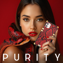 Load image into Gallery viewer, Woman holding a red snake skin phone case by PURITY.
